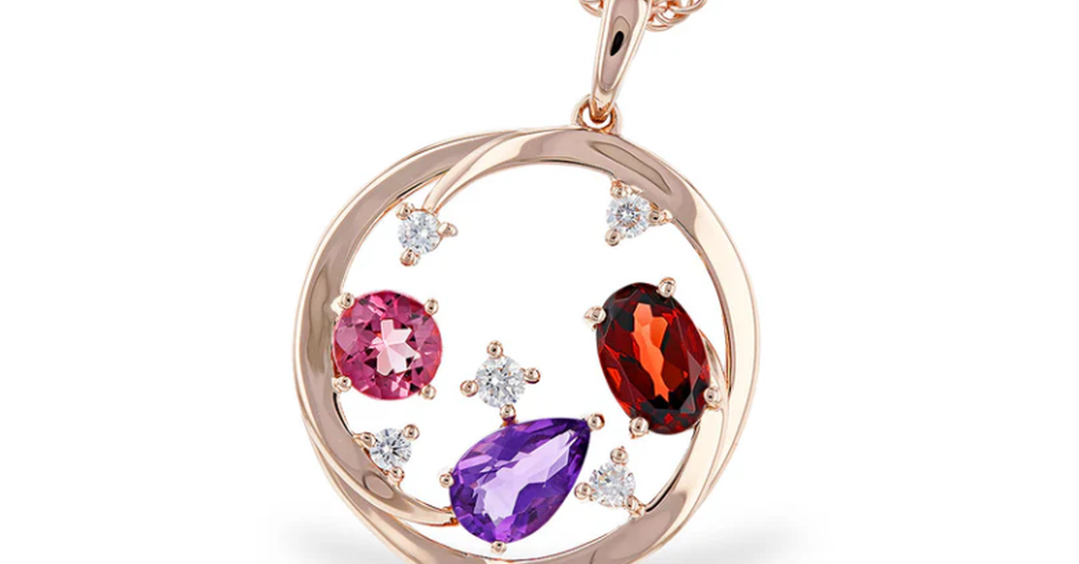 A rose gold pendant necklace with a circular open-frame design features diamonds and three gemstones in different cuts.